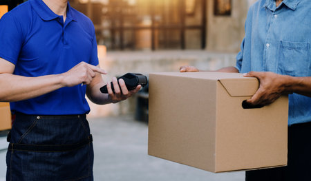 Entrepreneurs Small Business SME Independent men work at home Use smartphones and laptops for commercial checking, online marketing, packing boxes, SME sellers, concept, e-commerce team, online salesの写真素材