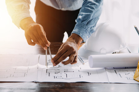 Architect having a meeting with construction team on siteの写真素材