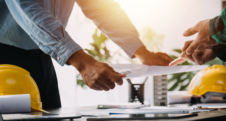 Architect having a meeting with construction team on siteの写真素材