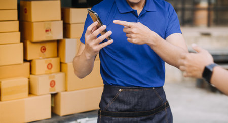 Entrepreneurs Small Business SME Independent men work at home Use smartphones and laptops for commercial checking, online marketing, packing boxes, SME sellers, concept, e-commerce team, online salesの写真素材