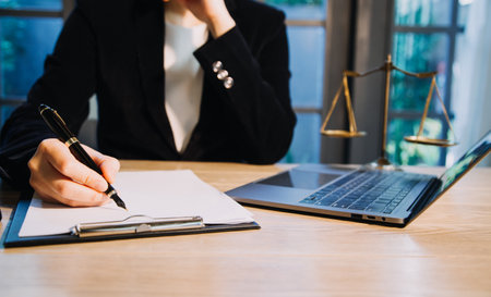 Justice and law concept.Male judge in a courtroom with the gavel, working with, computer and docking...