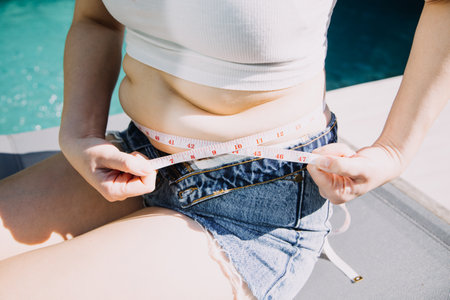 fat woman, fat belly, chubby, obese woman hand holding excessive belly fat with measure tape, woman...
