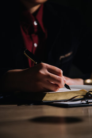 Justice and law concept.Male judge in a courtroom with the gavel, working with, computer and docking keyboard, eyeglasses, on table in morning lightの写真素材