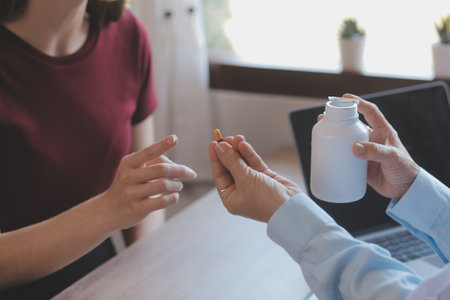 A health visitor with tablet explaining a senior woman how to take pills.の写真素材