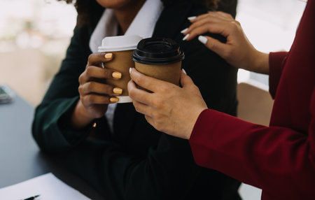 Entrepreneur Asian businessman and businesswoman discussing new business project in tablet in modern Meeting In Modern Office, Asian business casual concept.の写真素材