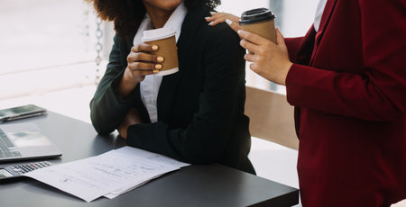 Asian Business woman using calculator and laptop for doing math finance on an office desk, tax, report, accounting, statistics, and analytical research conceptの写真素材