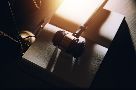 Business and lawyers discussing contract papers with brass scale on desk in office. Law, legal services, advice, justice and law concept picture with film grain effectの写真素材