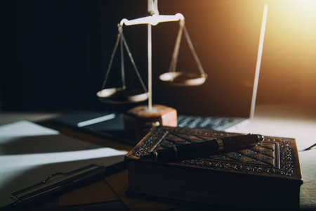 law legal technology concept. judge gavel on computer with scales of justice on desk of lawyer.