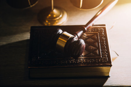 Business and lawyers discussing contract papers with brass scale on desk in office. Law, legal services, advice, justice and law concept picture with film grain effectの写真素材