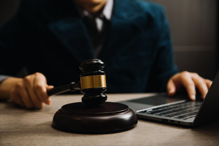 Business and lawyers discussing contract papers with brass scale on desk in office. Law, legal services, advice, justice and law concept picture with film grain effectの写真素材