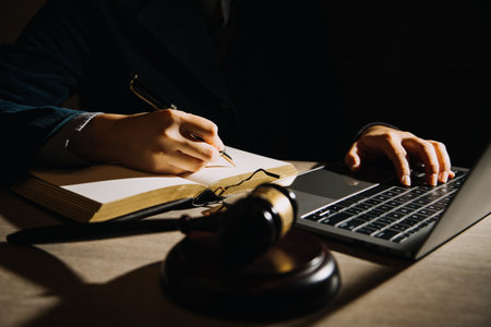 Business and lawyers discussing contract papers with brass scale on desk in office. Law, legal services, advice, justice and law concept picture with film grain effectの写真素材
