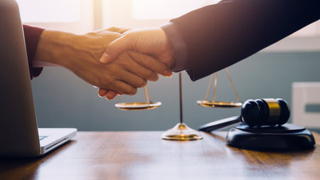 Businessman shaking hands to seal a deal with his partner lawyers or attorneys discussing a contract agreementの写真素材