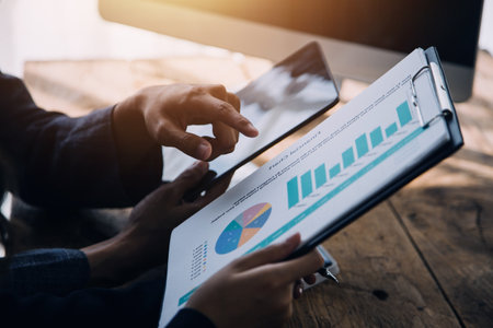 Financial Business woman analyze the graph of the company's performance to create profits and...