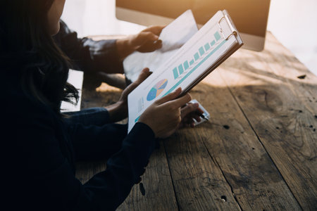 Financial Business woman analyze the graph of the company's performance to create profits and growth, Market research reports and income statistics, data,repotr,Financial and Accounting concept.の写真素材