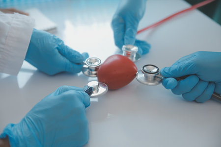 Mature doctors and young nurses stacking hands together at hospital. Close up hands of medical team stacking hands. Group of successful medical doctors and nurses stack of hands.の写真素材