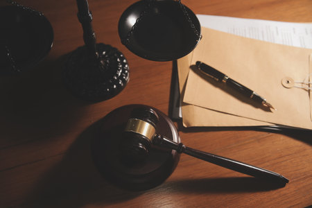 Business and lawyers discussing contract papers with brass scale on desk in office. Law, legal services, advice, justice and law concept picture with film grain effectの写真素材