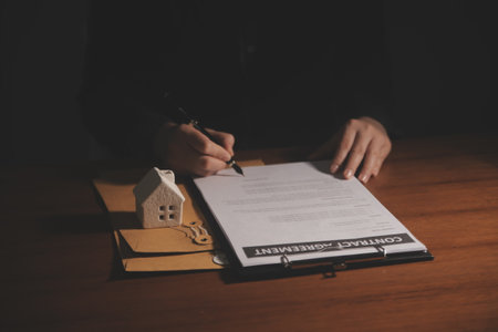 Real estate broker agent presenting and consult to customer to decision making sign insurance form agreement, buy and sell home model, concerning mortgage loan offer for and house insuranceの写真素材