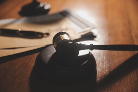 Business and lawyers discussing contract papers with brass scale on desk in office. Law, legal services, advice, justice and law concept picture with film grain effectの写真素材