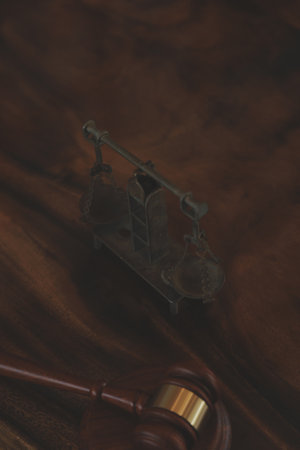 Justice and law concept.Male judge in a courtroom with the gavel, working with, computer and docking keyboard, eyeglasses, on table in morning lightの写真素材