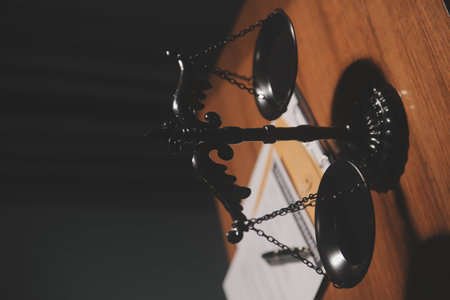 Business and lawyers discussing contract papers with brass scale on desk in office. Law, legal services, advice, justice and law concept picture with film grain effectの写真素材