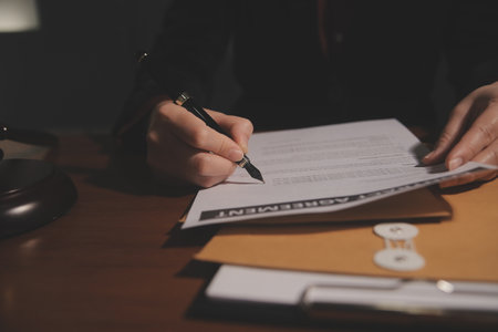 Business and lawyers discussing contract papers with brass scale on desk in office. Law, legal...