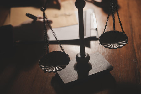 Business and lawyers discussing contract papers with brass scale on desk in office. Law, legal services, advice, justice and law concept picture with film grain effectの写真素材