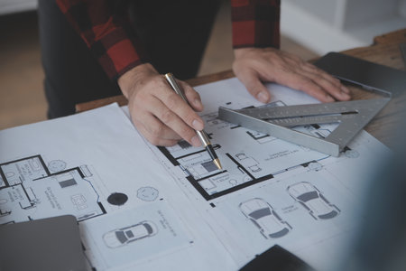 Construction and structure concept of engineer working drawing on blueprint meeting for project working with partner on model building and engineering tools in working site, construction concept.の写真素材