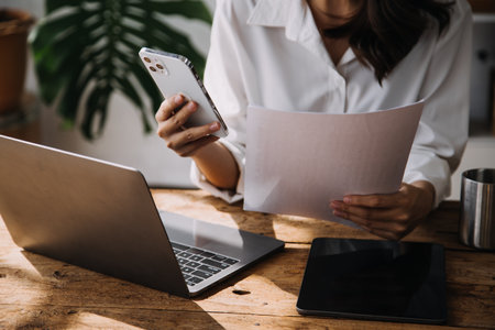 Business Man Financial Inspector and Secretary Making Report, Calculating or Checking Balance. Internal Revenue Service Inspector Checking Document Audit Conceptの写真素材