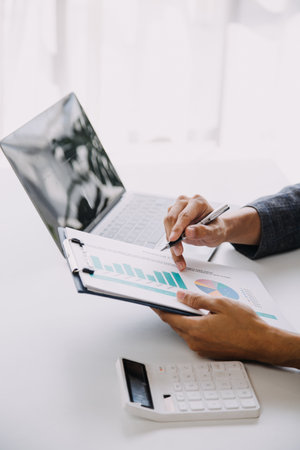 Entrepreneur Asian businessman and businesswoman discussing new business project in tablet in modern Meeting In Modern Office, Asian business casual concept.の写真素材