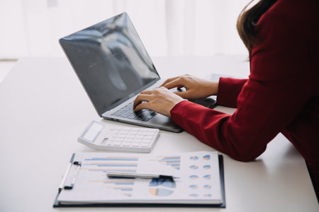 Entrepreneur Asian businessman and businesswoman discussing new business project in tablet in modern Meeting In Modern Office, Asian business casual concept.の写真素材