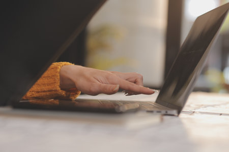 Cropped photo of Freelancer business Asian woman holding coffee cup and at doing planning analyzing the financial report, business plan investment, finance analysis the workplace.の写真素材
