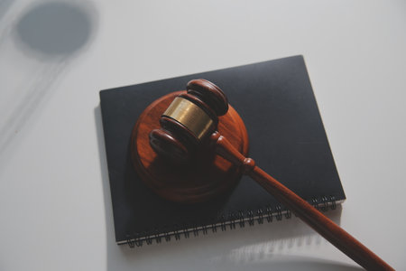 Business and lawyers discussing contract papers with brass scale on desk in office. Law, legal services, advice, justice and law concept picture with film grain effectの写真素材