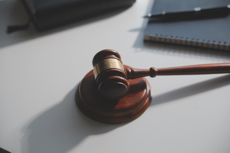 Business and lawyers discussing contract papers with brass scale on desk in office. Law, legal services, advice, justice and law concept picture with film grain effectの写真素材