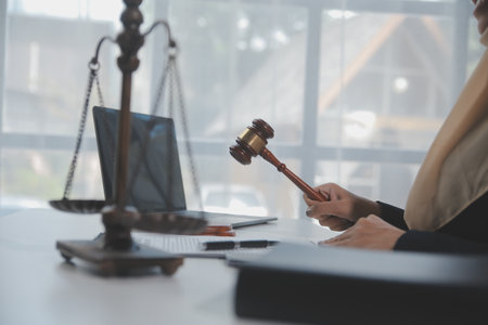 Business and lawyers discussing contract papers with brass scale on desk in office. Law, legal...