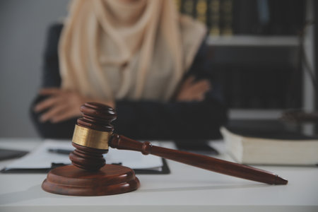 Business and lawyers discussing contract papers with brass scale on desk in office. Law, legal services, advice, justice and law concept picture with film grain effectの写真素材