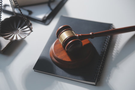 Business and lawyers discussing contract papers with brass scale on desk in office. Law, legal services, advice, justice and law concept picture with film grain effectの写真素材