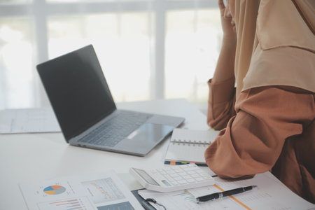 Businesswoman or accountant working Financial investment on calculator, calculate, analyze business and marketing growth on financial document data graph, Accounting, Economic, commercial concept.の写真素材