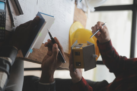 Engineer Teamwork Meeting, Drawing working on blueprint meeting for project working with partner on...