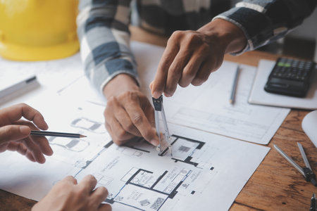 Engineer Teamwork Meeting, Drawing working on blueprint meeting for project working with partner on model building and engineering tools in working site, Construction and structure concept.の写真素材