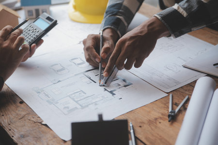 Engineer Teamwork Meeting, Drawing working on blueprint meeting for project working with partner on model building and engineering tools in working site, Construction and structure concept.の写真素材