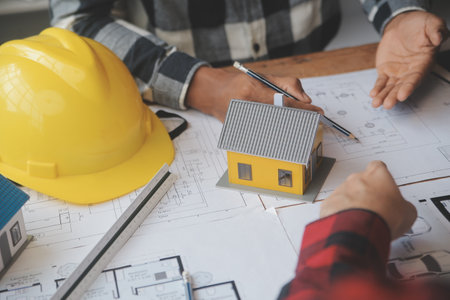 Engineer Teamwork Meeting, Drawing working on blueprint meeting for project working with partner on model building and engineering tools in working site, Construction and structure concept.の写真素材