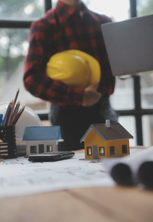 Engineer Teamwork Meeting, Drawing working on blueprint meeting for project working with partner on model building and engineering tools in working site, Construction and structure concept.の写真素材