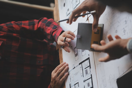 Engineer Teamwork Meeting, Drawing working on blueprint meeting for project working with partner on model building and engineering tools in working site, Construction and structure concept.の写真素材