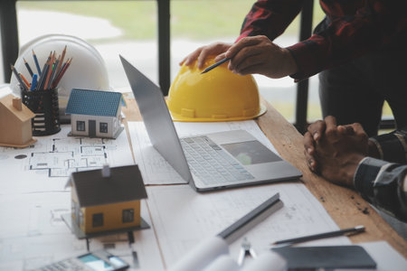 Engineer Teamwork Meeting, Drawing working on blueprint meeting for project working with partner on model building and engineering tools in working site, Construction and structure concept.の写真素材