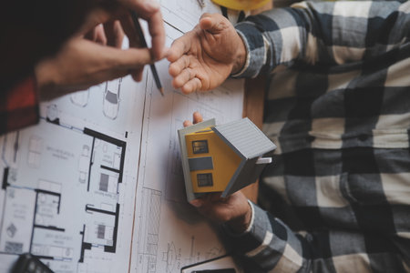 Engineer Teamwork Meeting, Drawing working on blueprint meeting for project working with partner on model building and engineering tools in working site, Construction and structure concept.の写真素材