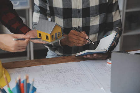 Engineer Teamwork Meeting, Drawing working on blueprint meeting for project working with partner on model building and engineering tools in working site, Construction and structure concept.の写真素材