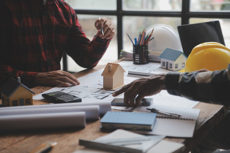Engineer Teamwork Meeting, Drawing working on blueprint meeting for project working with partner on model building and engineering tools in working site, Construction and structure concept.の写真素材