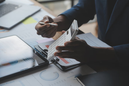 Financial analysts analyze business financial reports on a digital tablet planning investment...