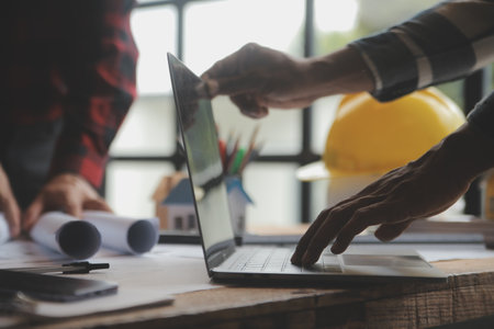 Engineer Teamwork Meeting, Drawing working on blueprint meeting for project working with partner on model building and engineering tools in working site, Construction and structure concept.の写真素材