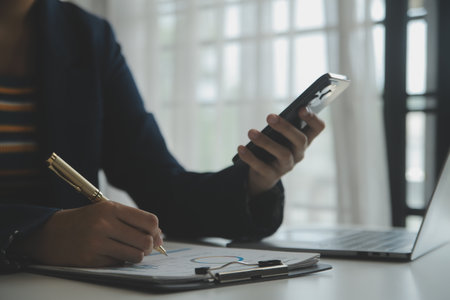 Entrepreneur Asian businessman and businesswoman discussing new business project in tablet in modern Meeting In Modern Office, Asian business casual concept.の写真素材